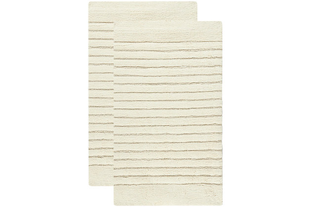 Turn any bathroom into a spa with this ultra-luxurious, extra dense, channel stripe bath rug. Featuring a sophisticated design loomed by hand, in combinations of high and low loops, for subtle tone-on-tone patterns. This bath mat contains a generous 2400 grams of cotton per square meter for luxurious softness underfoot and is backed with latex to prevent slipping.Set of 2 | 100% cotton | Natural | Non-slip latex backing | Machine wash | Imported