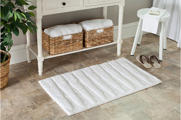 Add a lavish spa feel to the bath with the soft, fabulously functional, striped bath mat. An indulgent blend of cotton provides a luxurious softness underfoot, while a durable latex backing helps keep it firmly in place.Set of 2 | 100% cotton | White | Non-slip latex backing | Machine wash | Imported