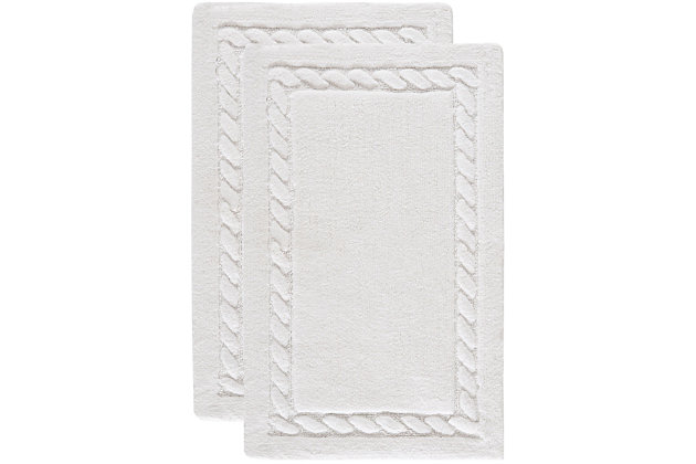 Treat yourself to a spa experience with this exceptionally soft cable patterned bath mat woven of lush, long-staple cotton for extra absorbency. Each bath mat contains a generous 2400 grams of cotton per square meter for luxurious softness underfoot and is backed with latex to prevent slipping.Set of 2 | 100% cotton | White | Non-slip latex backing | Machine wash | Imported