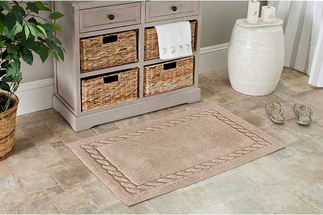 Treat yourself to a spa experience with this exceptionally soft cable patterned bath mat woven of lush, long-staple cotton for extra absorbency. Each bath mat contains a generous 2400 grams of cotton per square meter for luxurious softness underfoot and is backed with latex to prevent slipping.Set of 2 | 100% cotton | Linen | Non-slip latex backing | Machine wash | Imported