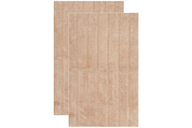 Add a lavish spa feel to the bath with this soft, fabulously functional, striped hand-tufted bath mat. Indulge in the luxury of plush and absorbent cotton every time you step on this reversible bath mat. One side is ribbed in elegantly simple vertical bands, while the other side is solid texture, all crafted from a deluxe 3000 grams of pure cotton.Set of 2 | 100% fine Indian cotton | Hand-tufted | Camel | Reversible (no backing) | Rug pad recommended to avoid shifting and sliding | Imported
