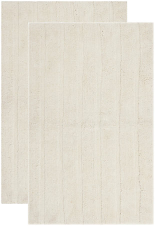 Add a lavish spa feel to the bath with this soft, fabulously functional, striped hand-tufted bath mat. Indulge in the luxury of plush and absorbent cotton every time you step on this reversible bath mat. One side is ribbed in elegantly simple vertical bands, while the other side is solid texture, all crafted from a deluxe 3000 grams of pure cotton.Set of 2 | 100% Indian cotton | Hand-tufted | Vanilla | Reversible (no backing) | Rug pad recommended to avoid shifting and sliding | Imported