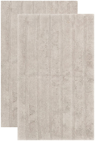 Add a lavish spa feel to the bath with this soft, fabulously functional, striped hand-tufted bath mat. Indulge in the luxury of plush and absorbent cotton every time you step on this reversible bath mat. One side is ribbed in elegantly simple vertical bands, while the other side is solid texture, all crafted from a deluxe 3000 grams of pure cotton.Set of 2 | 100% Indian cotton | Hand-tufted | Gray | Reversible (no backing) | Rug pad recommended to avoid shifting and sliding | Imported