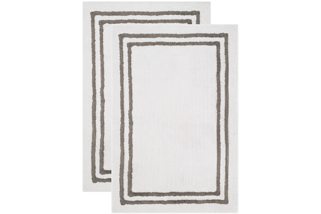 Add a lavish spa feel to your bath with this soft, fabulously functional, candy stripe bath mat. An indulgent blend of cotton provides a luxurious softness underfoot, while a durable latex backing helps keep the mat firmly in place.100% Indian cotton | White and dark gray | Non-slip latex backing | Machine wash | Imported