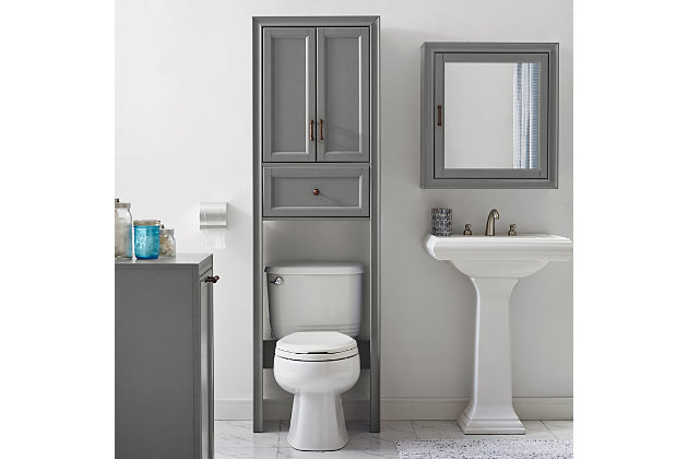 Bring a sense of order to your bathroom with this chic shelved tower. Designed to add much-needed bathroom storage, its roomy cabinet and drawer provide an elegant use of space. At home in the tightest or most spacious bath, its compact footprint allows you to live large in small places.Pine frame with birch veneer | Gray finish | Metal hardware with distressed brass-tone finish | Double door cabinet with shelf | Full-extension drawer | Space-saver design fits over most standard toilets | Assembly required