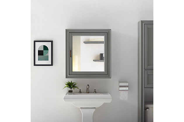 Bring a sense of order to your bathroom with this chic mirrored cabinet. Designed to add appeal while hiding its true function, its cottage styling and discreet cabinet storage provide an elegant use of space. At home in the tightest or most spacious bath, its compact size allows you to live large in small places.Pine frame with birch veneer | Gray finish | Metal hardware with distressed brass-tone finish | Mirrored door opens to reveal cabinet storage | Ready to hang | Assembly required