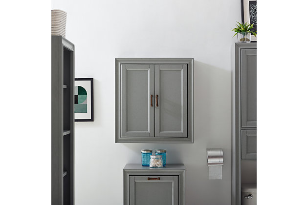 Bring a sense of order to your bathroom with this chic wall cabinet. Designed to add much-needed bathroom storage, its craftsman style doors and roomy cabinet provide an elegant use of space. At home in the tightest or most spacious bath, its compact size allows you to live in places.Pine frame with birch veneer | Gray finish | Metal hardware with distressed brass-tone finish | Double door cabinet space | Ready to hang | Assembly required