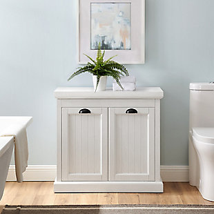 Bring a sense of order to your bathroom with this chic laundry hamper. Designed to add appeal while hiding its true function, this lift-top hamper with removable laundry bag provides an elegant use of space. At home in the tightest or most spacious bath, its compact footprint allows you to live large in small places.Pine wood and veneer frame | White finish | Faux cabinet front with beadboard detail and metal hardware | Lift-top lid with spring loaded anti-slam hinge | Removable cloth laundry bag | Assembly required
