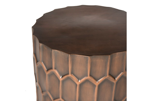A contemporary auction catalogue for a modernist Hungarian sculptor inspired this accent table. An antique copper finish adds depth and character to its honeycomb design. Ideal for a collector’s decor.Iron | No assembly required | Dust regularly with a soft, dry cloth; use adhesive felt pads/coasters to protect furniture; never use oiled/treated cloths on lacquered finishes