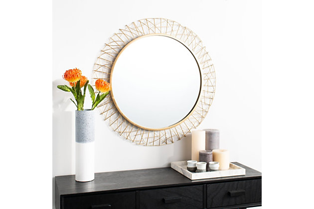 Designed to be a work of art, this contemporary mirror is an instant focal point in the living room or entryway. Crafted with the durability of iron, its gold finish illuminates the stunning intricate geometric cut-out pattern that frames its circular mirror.Paint, mdf, iron and mirrored glass | No assembly required | Because this item is handcrafted by artisans, no two are exactly alike. Each will have natural variations in patterning, shading and color