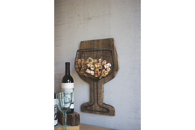 Savor the beauty of this wall-mount cork holder. Quality crafted of wood with a wire basket that turns your old corks into an art form, this shapely wall accent is sure to be a toastworthy addition to a dining room, kitchen or bar area.Made of wood and wire | Corks not included | Perfect for your bar or kitchen | Hand detailing makes each product  one of a kind