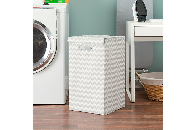Keep your laundry off the floor with this convenient Home Basics Chevron Hamper. The sturdy front handle makes it easy to carry from room to room, while the Velcro snap top keeps laundry in place.Made of non-woven materials | Holds 2 loads of laundry | Secured closed top keeps clothing in place | Collapsible design for easy, compact storage
