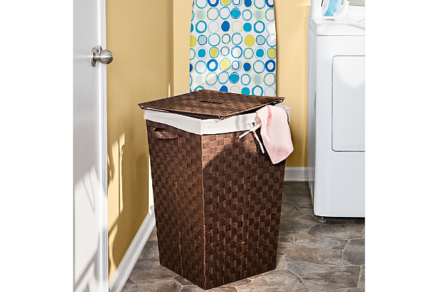 Your dirty laundry has come clean with you—it wants to be where it can look good even when it doesn’t smell good. That’s why you chose this Decorative Woven Hamper with Lid and propped it in the corner of your bedroom so all your garments can admire it from the inside out. Bathed in luxe Java Brown, this stylish hamper exudes a quiet sense of quality and confidence. Use the strap to easily remove its lid and its handles to tour it from room to room. Additionally, the natural linen liner protects your fabrics.Double-woven brown laundry hamper with handles for easy transport | Includes removable lid with handle | Natural linen liner helps to prevent snags on delicate garments