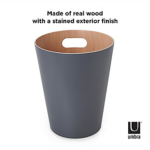 Add modern, contemporary style to a basic household essential. Introducing Woodrow Waste Can by Umbra Made of natural treated wood curved into a can shape, Woodrow warms and grounds a room, even though its core function is being a garbage can. Use Woodrow to add a modern, subtle decorative touch to your powder room, bathroom, office, study or wherever you choose to put it. This two-tone waste can fills any room with modern contemporary aesthetic and makes a great home office wastebasket or office recycling container. Woodrow is available in a wide range of finishes, all come with a natural wood finish on the interior. It features integrated handles that allow for easy transport and disposal of waste or recycling. Woodrow measures 9” diameter x 11” and has a capacity of 2 gallons (7.5 L), which is great for small spaces.CLEAN, MODERN DESIGN: Made of treated wood, Woodrow has a natural wood interior and is available in a wide-range of exterior finishes | EASY TO TRANSPORT: Woodrow features integrated handles for easy transport and disposal of its contents | FUNCTIONAL & DURABLE: This modern trash can's open-top design features durable, high-quality construction | 2 GALLON CAPACITY: Woodrow has a 2-gallon (7.5 L) capacity that is perfect even in small spaces