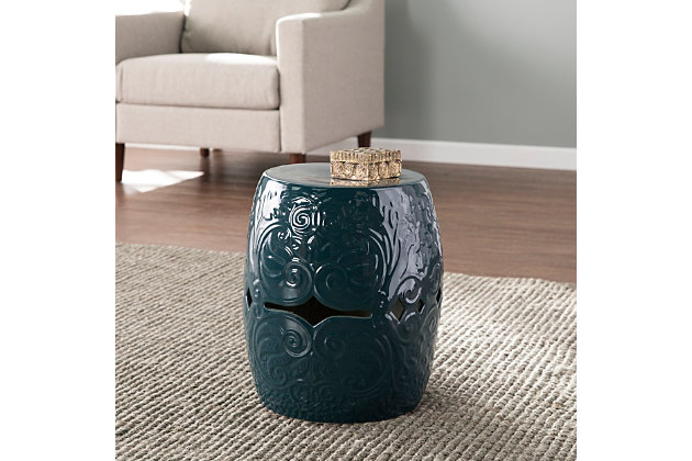 Make style waves with this ceramic side table. Textured scrollwork unfurls across the glossy base, while curvy cutouts welcome sea breezes and sunny skies. Upgrade your design scheme when you add this round accent table.Made of ceramic | Blue glossy finish | Small Space Solution | No assembly required