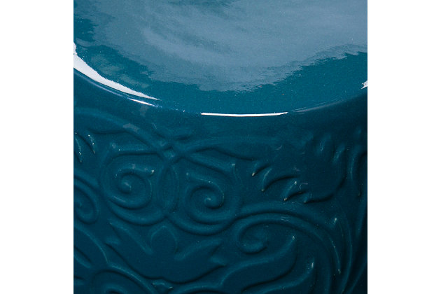 Make style waves with this ceramic side table. Textured scrollwork unfurls across the glossy base, while curvy cutouts welcome sea breezes and sunny skies. Upgrade your design scheme when you add this round accent table.Made of ceramic | Blue glossy finish | Small Space Solution | No assembly required