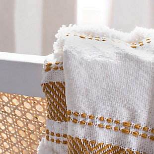 Featuring finely embroidered stripes, dots and chevrons, this throw lends an artistic sense of depth to room decor. The raised-pattern design and playful tassels offer must-touch texture, beautifully blending rustic-chic style with subtle hints of glamour in cream and mustard tones. This designer throw is made using 100% cotton for lasting comfort and quality.Made of cotton | Imported | Dry clean only