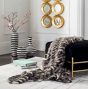Give in to your animal instinct with this soft, seductive faux fur throw. The subtle splash of alluring color will add an exotic touch to your room decor. Not to mention, you’ll go wild for its luxurious, textural feel.Front made of acrylic; back made of poly suede | Imported | Machine washable