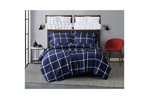 Simple lines make the best coordinates for your room. A medium size windowpane pattern is a perfect coordinate to any busy room or if you are looking for a modern look.  The gray and charcoal gray colors use a white base and the navy version uses an inverse with navy as the background and white as line pattern color. The individual panes have added depth as the cross bars use a textured striping style and the intersecting points are completely solid.  This design adds more depth to the pattern without adding complexity.  Made from 100% microfiber polyester items are made for use throughout the year.This item is machine washable, but care should be taken to wash in appropriate size equipment to avoid damage. | Face is made from 100% microfiber polyester yarns in a percale weave and printed. | This item is imported from china. | Simple larger scale plaid pattern