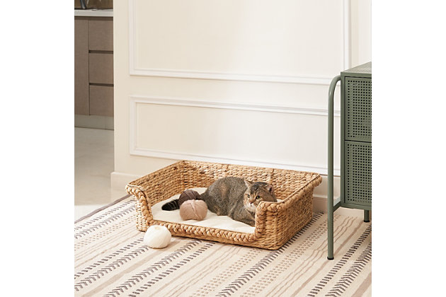 Simple, comfortable and stylish, this handwoven water hyacinth cat house with cushion is not only perfect for your cat but is also a piece of rustic decor for your home. Woven from eco-friendly water hyacinth with thick braids and a rice nut weave, and supported by a rustproof iron frame, it's strong and durable. The soft, comfortable cushion offers the most wonderful place for your cat to play and enjoy. Its natural golden and toffee-colored finish brings a soothing, natural feel to your home. This lightweight cat house can also be easily moved from place to place.Made of natural water hyacinth and iron | Natural finish | Medium size with cushion (weight capacity 52 pounds) | Lightweight | Eco-friendly | No assembly required