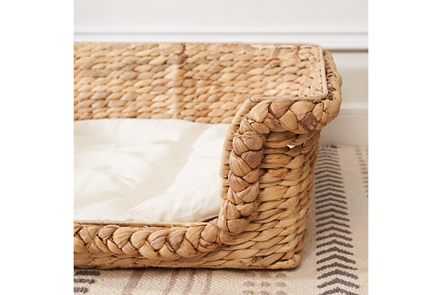 Simple, comfortable and stylish, this handwoven water hyacinth cat house with cushion is not only perfect for your cat but is also a piece of rustic decor for your home. Woven from eco-friendly water hyacinth with thick braids and a rice nut weave, and supported by a rustproof iron frame, it's strong and durable. The soft, comfortable cushion offers the most wonderful place for your cat to play and enjoy. Its natural golden and toffee-colored finish brings a soothing, natural feel to your home. This lightweight cat house can also be easily moved from place to place.Made of natural water hyacinth and iron | Natural finish | Medium size with cushion (weight capacity 52 pounds) | Lightweight | Eco-friendly | No assembly required