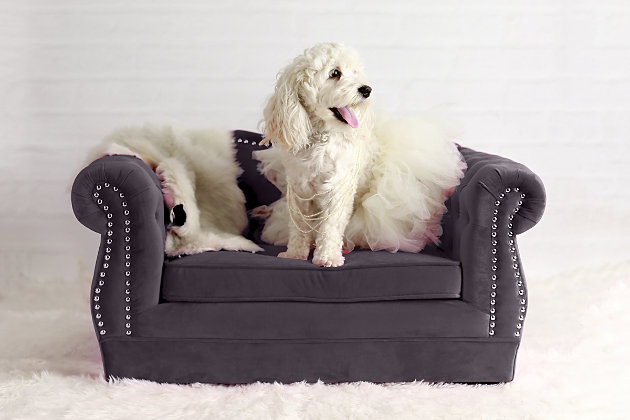 Pamper your pet and add a touch of style to any room with this pet bed that's easy on the eyes. Your four-legged family member can sleep comfortably any time of day without being separated from family activity. The luxurious pet sofa features a button-tufted back and hand-applied nailhead trim. Its washable, waterproof velvet is easy to clean and sure to last.Wood frame | Upholstered in waterproof velvet fabric | Handmade | Removable, washable cushion | No assembly required | Imported