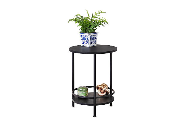 This 2-tier round side table screams simplicity, with its sophisticated black color the perfect complement to any furniture. Put magazines on the bottom shelf of the end table and your favorite family picture on the top, or keep the top clean and use it as the spot to rest your cup of coffee.Simple round side table for displaying photos or other accessories | 2-tiers provide double the display or storage space | Sleek black finish fits with any décor | Mdf material with pvc tubes