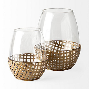 Featuring an intricate, woven metal base finished in a gold-tone with a curved hurricane glass cover, the Reena is a spectacular votive holder that looks absolutely gorgeous in any modern space.Featuring an intricate, woven metal base finished in a gold-tone with a curved hurricane glass cover, the Reena is a spectacular votive holder that looks absolutely gorgeous in any modern space.