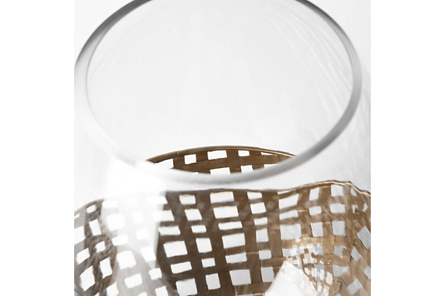 Featuring an intricate, woven metal base finished in a gold-tone with a curved hurricane glass cover, the Reena is a spectacular votive holder that looks absolutely gorgeous in any modern space.Featuring an intricate, woven metal base finished in a gold-tone with a curved hurricane glass cover, the Reena is a spectacular votive holder that looks absolutely gorgeous in any modern space.