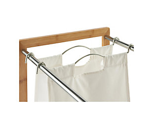 TRINITY's EcoStorage 3-Bag Bamboo Laundry Cart is a great addition to any laundry, closet, bathroom, or bedroom area. The strong 100% pre-shrunk cotton bags are large enough to hold loads of all sizes while allowing for easy sorting of all laundry items. This 3-Bag Bamboo Laundry Cart is the perfect blend of form and function, giving plenty of options for laundry organization while looking sleek.Wood and Metal | Bamboo and chrome color poles | EcoStorage™ finish represents eco-friendly production; No toxic chemicals are released into the environment during the production of this product | 3 large 14" W x 9" D x 24" H laundry bags; 100% Cotton bags; Pre-shrunk; Machine washable | Weight capacity of sorter (evenly distributed); 15 lb per bag; 40 lb total weight | (4) - 2"  x 1"  swivel wheels; (2) locking, (2) non-locking | Chrome-tone powder coated bag handles; Easily removable;  Curved handle design for easy grab-n-go; Rubber tipped ends | Assembly required