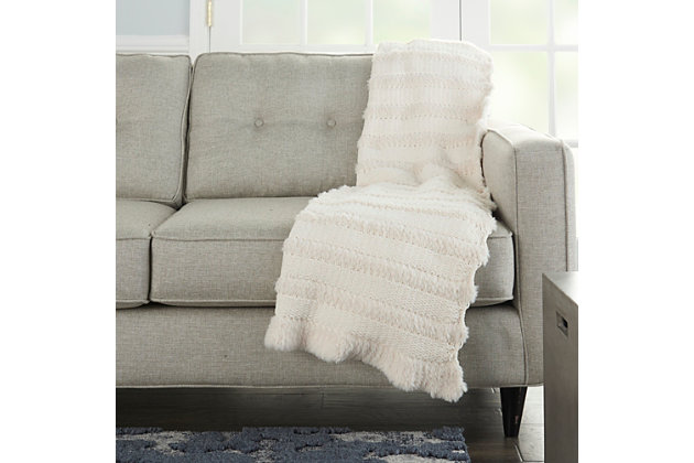 This throw blanket is a perfect layering piece for any couch, chair or bed. Luxurious to the touch, it has a high-end design, look and feel making it super soft, warm and extremely cozy. Each throw blanket is large enough to use as a blanket and stylish enough to use as an accent piece.Handcrafted | Indoor only | Spot clean | Ivory | Polyester | Throw blanket | Imported