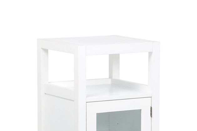Have a little unused spot in your bathroom? This compact floor storage cabinet would be perfect! One interior shelf behind a tempered glass door and an open shelf provides storage space for towels, toiletries or paper supplies. This beautiful cabinet offers a surprising amount of storage for such a small footprint. Efforts are made to reproduce accurate colors, variations in color may occur due to computer monitor and photography. At Simpli Home we believe in creating excellent, high quality products made from the finest materials at an affordable price.DIMENSIONS: 14.17" D x 15" W x 29.9" H | Constructed using solid Acacia, Engineered Wood and Tempered Glass | Durable white painted finish sealed with a premium NC lacquer coating | One tempered glass door with adjustable interior shelf and one (1) open bottom shelf. Brushed nickel hardware | Framed detail on side panels | Contemporary styling | Assemby Required | We believe in creating excellent, high quality products made from the finest materials at an affordable price. Every one of our products come with a 1-year warranty and easy returns if you are not satisfied.
