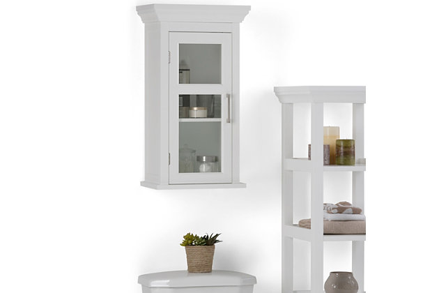 You need a little more storage than what your medicine cabinet has to offer. Consider this compact wall cabinet with an adjustable shelf. It offers you extra room for cosmetics, medicines, and other bath items. Efforts are made to reproduce accurate colors, variations in color may occur due to computer monitor and  photography. At Simpli Home we believe in creating excellent, high quality products made from the finest materials at an affordable price.Constructed using high quality MDF, Rubberwood and Tempered Glass; Durable Pure White painted finish sealed with a premium NC lacquer coating | One (1) door with one (1) adjustable interior shelf. Contemporary Brushed Nickel handles | Shaker styled front and side panels with molded top detail, Rubber wood frame; Dimensions: 15"w x 10" d x 27" H | Adjustable interior shelf; Contemporary styling