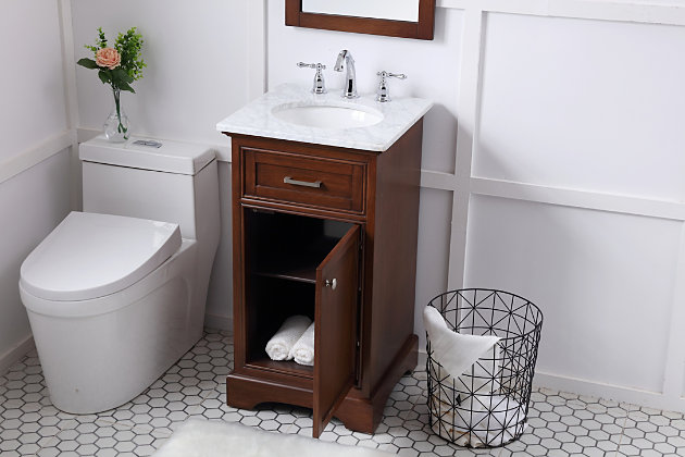 From its Italian Carrara white marble top to its contemporary-style hand-painted cabinet, this vanity is sure to enhance your home or office bathroom. Beneath its lustrous natural marble top and oval white porcelain sink is a handsome single-door cabinet with a storage shelf inside for all your bathroom essentials. This vanity is highlighted with recessed panel doors and a brushed steel bar handle and knob, and sits on a strong, solid base. A wonderful balance of simplicity and practical function.Made of wood, marble and porcelain | White carrara marble countertop with flat-edge cut | Single porcelain undermount sink | Brushed steel hardware | Soft-close cabinet door with single shelf | Faux drawer | Pre-drilled faucet holes; faucet not included | No assembly required