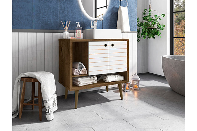 Refresh your bathroom or powder room space with the Liberty vanity. This vanity offers storage and style all at once. Beautiful splayed legs and detailed cabinet doors are seamless and versatile, easily blending with any interior design. Cabinet doors conceal shelving space to help arrange personal items, cleaning supplies and more, while a lower open shelf is great for tucking away extra toiletries, diffusers or candles. Open side storage stashes away extra supplies and displays towels, giving your bathroom that hotel feel.Freestanding vanity with sink for bathroom usage | White and rustic brown finish | Made with wood | Sink made with faux marble; vessel faucet installation type | Splayed legs made with solid wood for extra durability | Includes 2 open shelves for storage and 2 doors concealing water pipes | 90-degree open door style with soft-close features and ring cutout knobs with sleek lateral line indent design | Assembly required