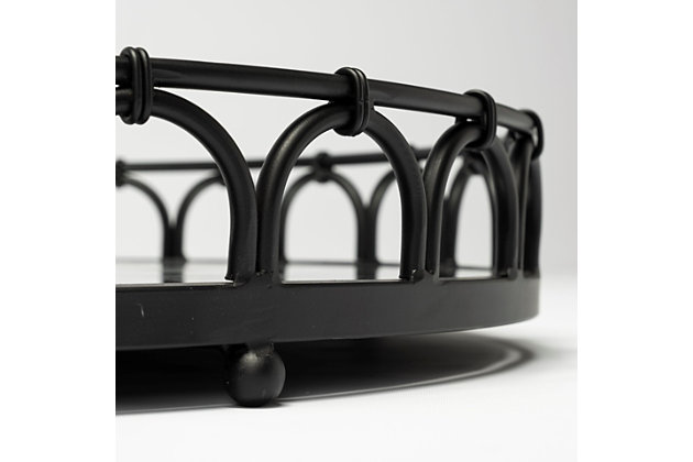 Crafted from metal and finished in a matte black tone, this stunning round tray  flaunts a mirrored glass bottom and intricately styled railings. With an elegant design that is complemented by the uni-tone finish, it fits perfectly in spaces based on the Mercana Modern design style.Made with metal | Mirror inlay | Finished in matte black | Curved semi-circle design on frame | No assembly required