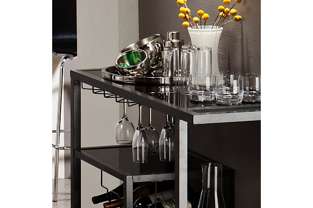 The Zephs bar cart is just what’s needed to turn any home into party central. Its crisp, clean and ultra-modern design includes a chic gunmetal finish complemented by black glass shelves. This bar cart’s four-tier asymmetry stirs things up beautifully, while built-in wine bottle and stemware racks simply work.Made of powdercoated metal and iron with black glass shelves | Gunmetal gray finish | Includes racks for 4 wine bottles and approximately 8 wine glasses | Locking casters for mobility and functionality | Assembly required | Assembly time frame is 15 to 30 min.