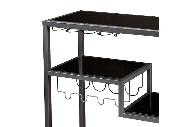 The Zephs bar cart is just what’s needed to turn any home into party central. Its crisp, clean and ultra-modern design includes a chic gunmetal finish complemented by black glass shelves. This bar cart’s four-tier asymmetry stirs things up beautifully, while built-in wine bottle and stemware racks simply work.Made of powdercoated metal and iron with black glass shelves | Gunmetal gray finish | Includes racks for 4 wine bottles and approximately 8 wine glasses | Locking casters for mobility and functionality | Assembly required | Assembly time frame is 15 to 30 min.