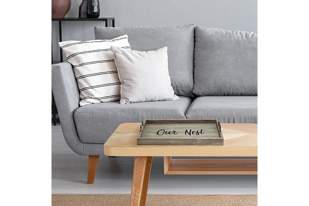 Freshen up your home with this rustic gray wooden tray!  Accented with black metal handles and black text this tray is on trend to give your home that cozy farmhouse feel.  Use to serve breakfast in bed, food and drinks at a party or makes for an excellant centerpiece for your dining table, kitchen counter, coffee table or ottoman.Rustic gray finish on wood | Black "home" text | Black metal handles | On-trend farmhouse design | Tray measures l: 15.50" x w: 12" x h:2.25"