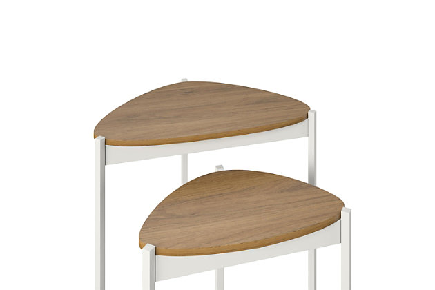 Add unique and space-saving table space to your living room with the Novogratz Tallulah Nesting Tables. Made of laminated particleboard with sturdy powder-coated metal legs, the warm walnut woodgrain finish on the tabletops pairs perfectly with the white metal legs for a beautiful look for your space. Use the tables separately to hold all of your drinks and snacks for movie or game night and simply stack them together when not in use to save valuable space. The compact design is perfect for first apartments and smaller spaces. The unique tabletop shape is sure to make the tables stand out and complement your style. The Nesting Tables ship flat to your door and require minimal assembly upon opening. Once assembled, the taller table measures to be 24"H x 23.8"W x 15.7"D and the shorter table measures to be 20.9"H x 17.7"W x 11.3"D.Get space-saving table space for your room with the novogratz tallulah nesting tables | Made of laminated particleboard with sturdy powder-coated metal legs, the warm walnut woodgrain finish on the tabletops pairs perfectly with the white metal legs | Get additional table space for snacks, remotes, and drinks by using the 2 tables as convenient end tables | Stack the tables together to save space and still be able to use the taller table for essentials | The nesting tables ship flat to your door and require minimal assembly upon opening. The taller table can hold up to 20 lbs. While the shorter table can hold 15 lbs. Assembled taller table dimensions: 24"h x 23.8"w x 15.7"d. Assembled shorter table dimensions: 20.9"h x 17.7"w x 11.3"d | 1 year limited warranty included