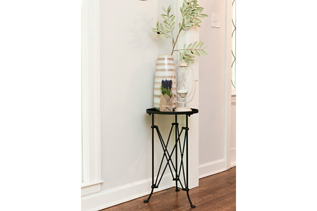This accent table is the perfect size for just about anywhere in the home.  The slightly distressed black finish coupled with whimsical feet make it a unique choice for any décor.  Some assembly is required.Metal construction | Top tray is 14.5" round with 1" raised sides | Legs are 1" round and 25" high | Wipe clean with dry cloth | 15.25l x 14.25w x 25.75h in.