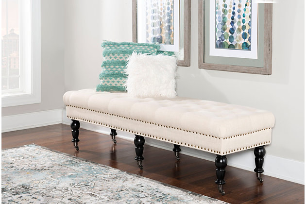 Given its scale, the richly styled Isabelle bedroom bench looks perfectly placed at the foot of the bed. Of course, it’s just as welcome and practical in an entryway or under a window. Deep tufting enhances the bench’s natural linen fabric, while classically turned legs in a dark espresso finish are a striking complement. Casters make it easy to enjoy.Made with solid wood, birch | Polyester linen upholstery | Ca fire foam cushion | Tufted seat | Bronze-tone nailhead trim | Casters for easy mobility | Exposed legs with dark espresso finish | Assembly required