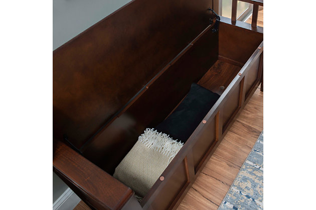 The Cynthia storage bench is such a welcome addition to an entryway or mudroom. Sporting a flip-top seat, this stylish storage bench offers a clean and classic aesthetic with slat back and sides and a richly rustic walnut finish.Made of chinese hardwood, engineered wood and plywood | Walnut finish | Flip-top seat with hinges opens to storage compartment | Assembly required