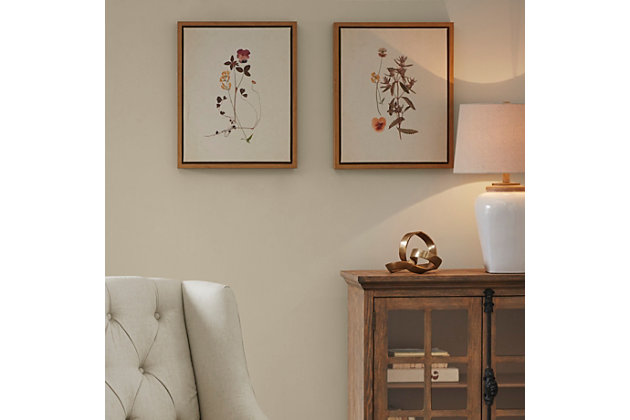 Add cottage-inspired charm to your home decor with this Martha Stewart framed canvas herbarium set. Each piece features quaint wildflowers that create a charming transitional look. Each piece uses a sawtooth fixture on the back to make them easy to display. Soften your space by incorporating this wall art set into your bedroom, kitchen or living room.Set of 2 | Made of linen canvas, engineered wood and polystyrene | White and gray | Gallery wrapped canvas | Giclee reproduction | Ready to hang (sawtooth hangers) | Indoor use only | Imported
