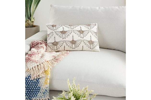 Art deco meets modern glam in this plush handmade mina victory lumbar pillow. Across its neutral ivory cotton cover, beaded floral motifs create a glamorous effect on your sofa, bed or chair. This lumbar pillow includes a springy polyester insert to help retain its rectangular shape, and a zipper closure for easy spot cleaning.Handcrafted | Made of 100% cotton | Soft polyfill | Zipper closure | Beaded floral motifs | Imported | Spot clean