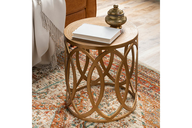 If you’ve been holding out for a boho-chic look that’s delightfully unique, this handcrafted round end table is clearly worth waiting for. Brass-tone metal rings are topped with a sculpted metal tabletop, for a masterfully modern look with minimal fuss.Made of metal | Handcrafted | Frame and tabletop with brass-tone finish | Indoor use only | Clean with soft, dry cloth | Assembly required