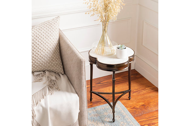 Embodying time-honored designs that have been revered for generations, this accent table redefines vintage charm from room to room within your living space. Its handcrafted construction exudes natural ambience and grace, effortlessly adding a tasteful touch of sophistication into your home.Made of metal and marble | Handcrafted | White marble tabletop | Metal frame with brass-tone finish | Indoor use only | Clean with soft, dry cloth | Assembly required