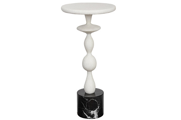 Make a modern statement with this inverse drink table. The black and white accent piece is executed in a rich granulated marble material that accurately replicates the look of Thassos marble, giving the piece an irresistible Mediterranean flair. A large black marble base adds the finishing touch.Made of marble and wood | White with granulated design | Black base