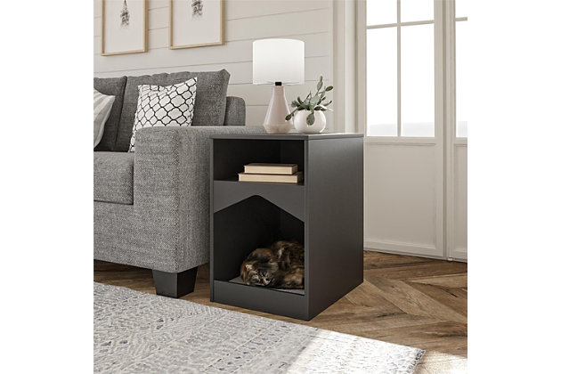Your feline friend will have their own spot to lounge around all day with the Ollie & Hutch Roscoe Cat House End Table. Made of laminated particleboard, the sleek black finish will look great with any style and features a gray microfiber cushion so your cat can snooze away right by your side. The End Table offers an open cubby for you to organize electronics and reading material. The tabletop is perfect for a reading lamp and to hold snacks and electronics while watching your favorite shows and movies. The Cat House End Table ships flat to your door and requires assembly upon opening. Two adults are recommended to assemble. Once assembled, the End Table measures to be 24.06”H x 15.79”W x 20.04”D.Give your cat the perfect spot for a cat nap with the ollie & hutch roscoe cat house end table | Made of laminated particleboard with a classic black finish, the end table offers a gray microfiber cushion | The open cubby and tabletop can organize all of your electronics, reading material, and snacks | The cat house end table ships flat to your door and 2 adults are recommended to assemble. The tabletop and cat house can each hold 50 lbs. While the cubby can hold 20 lbs. Assembled dimensions: 24.06”h x 15.79”w x 20.04”d | 1 year limited warranty is included