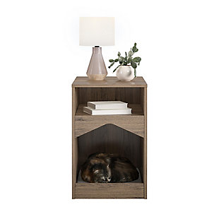 Your feline friend will have their own spot to lounge around all day with the Ollie & Hutch Roscoe Cat House End Table. Made of laminated particleboard, the brown woodgrain finish will look great with any style and features a gray microfiber cushion so your cat can snooze away right by your side. The End Table offers an open cubby for you to organize electronics and reading material. The tabletop is perfect for a reading lamp and to hold snacks and electronics while watching your favorite shows and movies. The Cat House End Table ships flat to your door and requires assembly upon opening. Two adults are recommended to assemble. Once assembled, the End Table measures to be 24.06”H x 15.79”W x 20.04”D.Give your cat the perfect spot for a cat nap with the ollie & hutch roscoe cat house end table | Made of laminated particleboard with a brown woodgrain finish, the end table offers a gray microfiber cushion | The open cubby and tabletop can organize all of your electronics, reading material, and snacks | The cat house end table ships flat to your door and 2 adults are recommended to assemble. The tabletop and cat house can each hold 50 lbs. While the cubby can hold 20 lbs. Assembled dimensions: 24.06”h x 15.79”w x 20.04”d | 1 year limited warranty is included